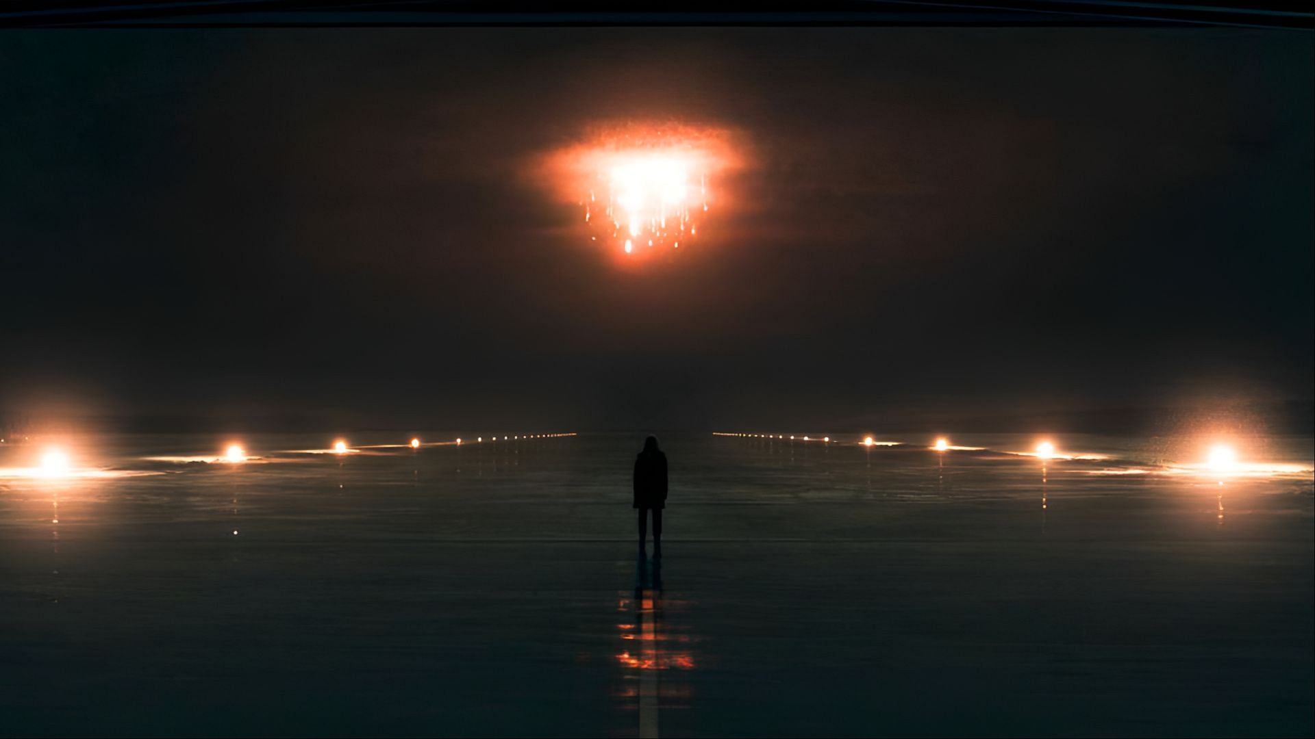 June watches from the runway as the plane carrying Commander Lawrence, Nick, and Wharton explodes (Image via Hulu)